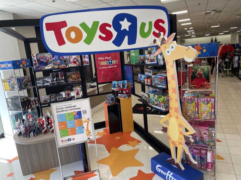 A Toys R Us display showing shelves of toys and Geoffrey the cartoon giraffe mascot greet visitors to Macy's in Augusta Mall, Oct. 19, 2022. The toy retailer that filed for bankruptcy in 2017 has reopened inside Macy's nationwide.