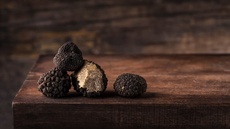 Black truffles on dark table