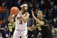 Illinois' Jacob Grandison (3) looks for a passing outlet as Michigan's Caleb Houstan defends during the second half of an NCAA college basketball game Friday, Jan. 14, 2022, in Champaign, Ill. (AP Photo/Michael Allio)