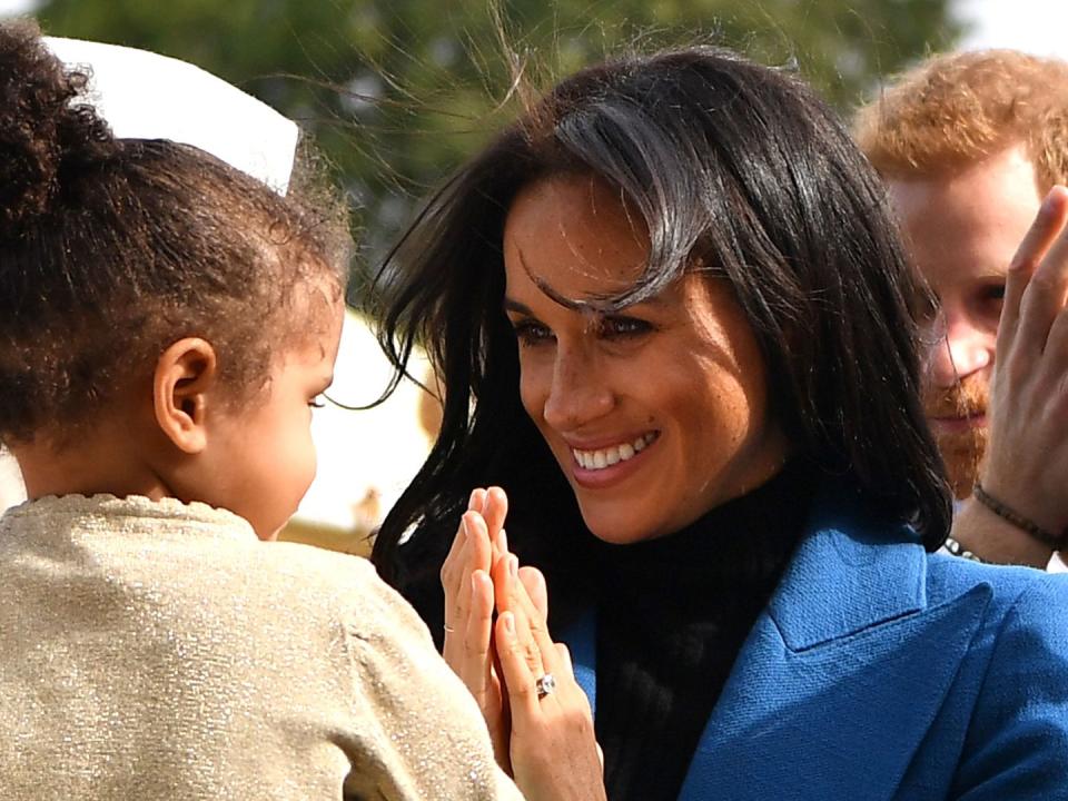 <p>Meghan bonds with a young girl at the launch of the duchess' cookbook, which was to raise money for those affected by the Grenfell tragedy.</p>