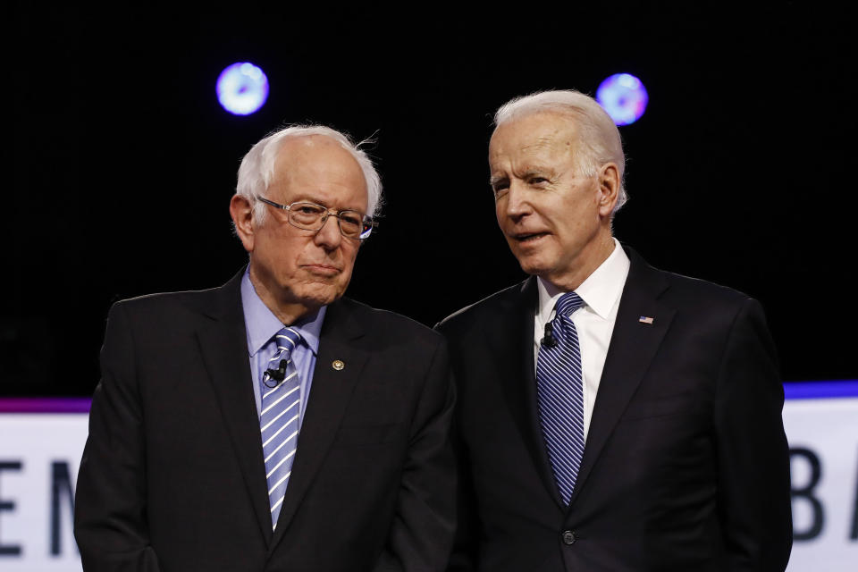 FILE - Democratic presidential candidates, Sen. Bernie Sanders, I-Vt., left, and former Vice President Joe Biden, talk before a Democratic presidential primary debate in Charleston, S.C., on Feb. 25, 2020. (AP Photo/Matt Rourke, File)