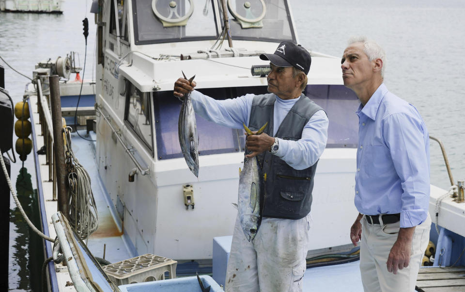 U.S. Ambassador to Japan Rahm Emanuel, right, speaks with a fisherman at a fishing port on Yonaguni Island in Okinawa prefecture, southern Japan Friday, May 17, 2024. Emanuel visited two southwestern Japanese islands at the forefront of tension with China's increasingly assertive actions in the regional waters. (Kyodo News via AP)