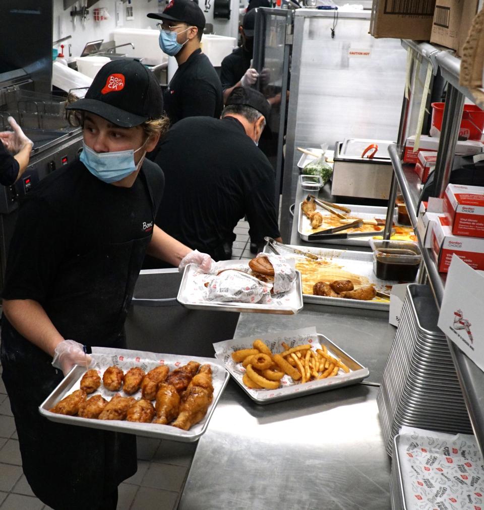 Inside the busy kitchen of Bonchon Chicken on its opening day, Dec. 28, 2021.