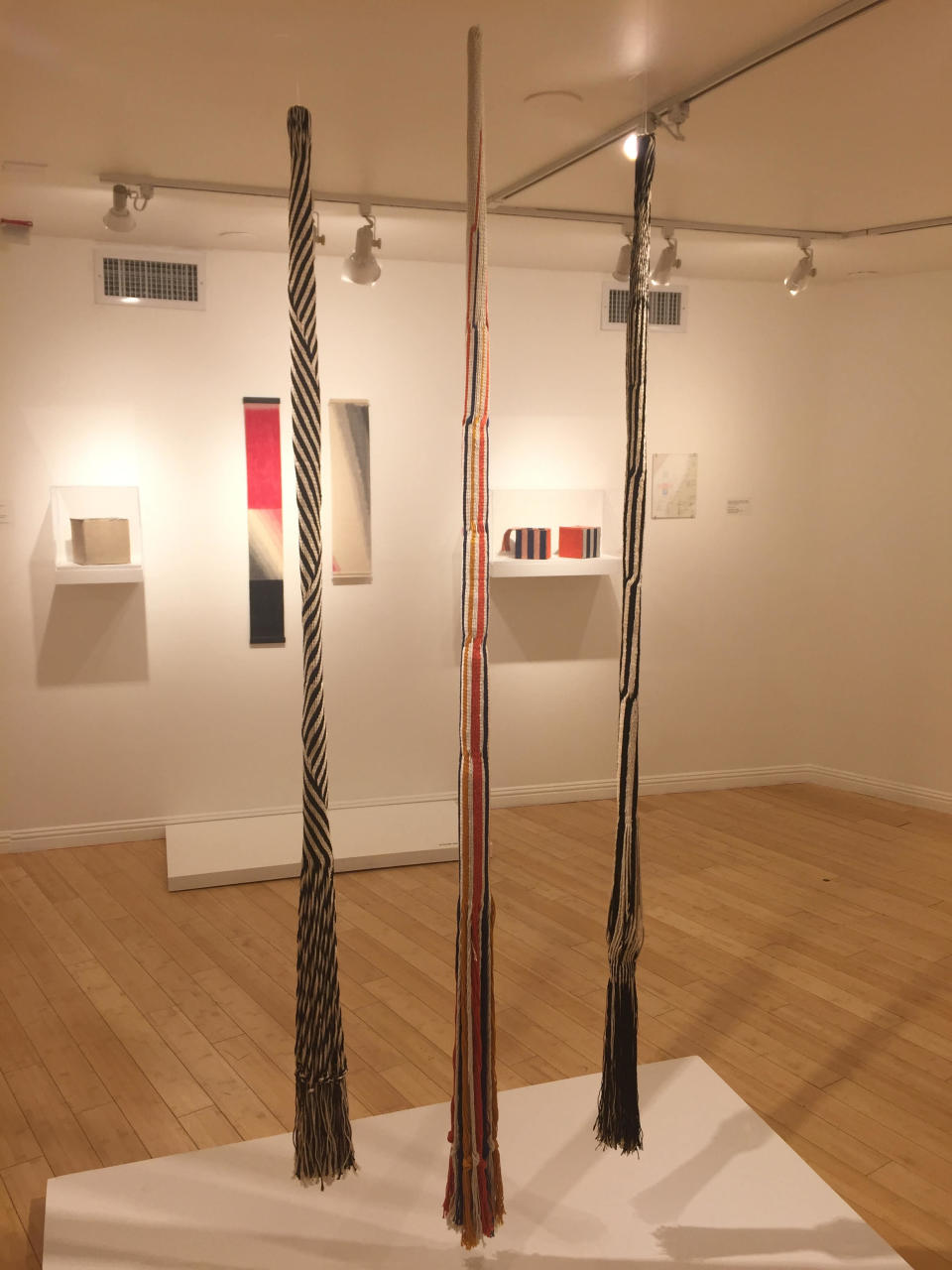 This photo taken on Dec. 2, 2016 shows woven tubes "Marugawa I" (1974), "Marugawa IV" (1978) and "Marugawa II" (1974) by Berkeley, Calif., based 90-year-old fiber artist and weaver Kay Sekimachi. The pieces are part of the "Kay Sekimachi: Simple Complexity" exhibit the Craft and Folk Art Museum in Los Angeles, chronicling Sekimachi's decades-long career. The exhibit opened on Sept. 25, 2016, and runs through Jan. 8, 2017. (Solvej Schou via AP)