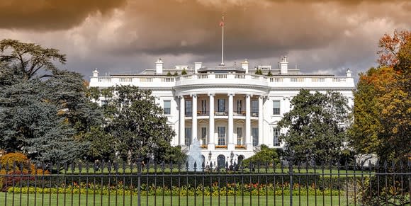 The White House with storm clouds in background.