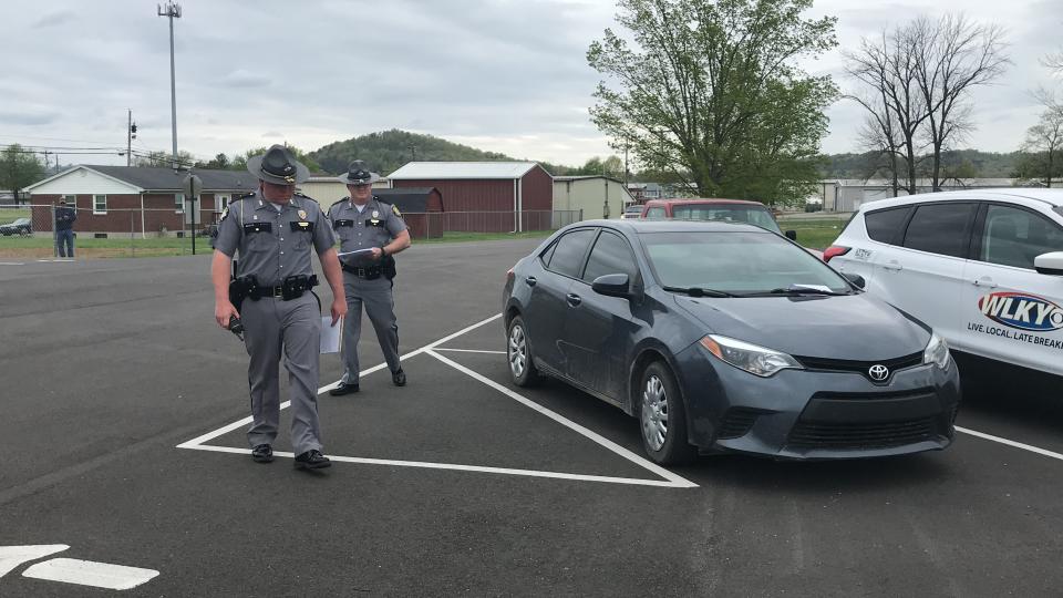 Kentucky state troopers take down license plates of people attending an in-person Easter service at Maryville Baptist Church in Hillview, Kentucky.