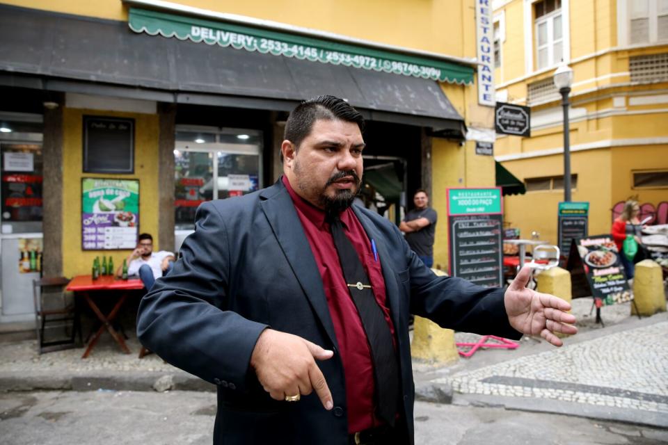 A man talks to reporters.