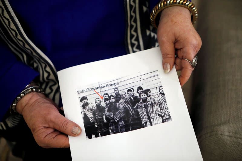 Holocaust survivor Vera Grossman Kriegel shows an image of herself as a child after the liberation of Auschwitz during an interview with Reuters in Oranit, in the Israeli-occupied West Bank