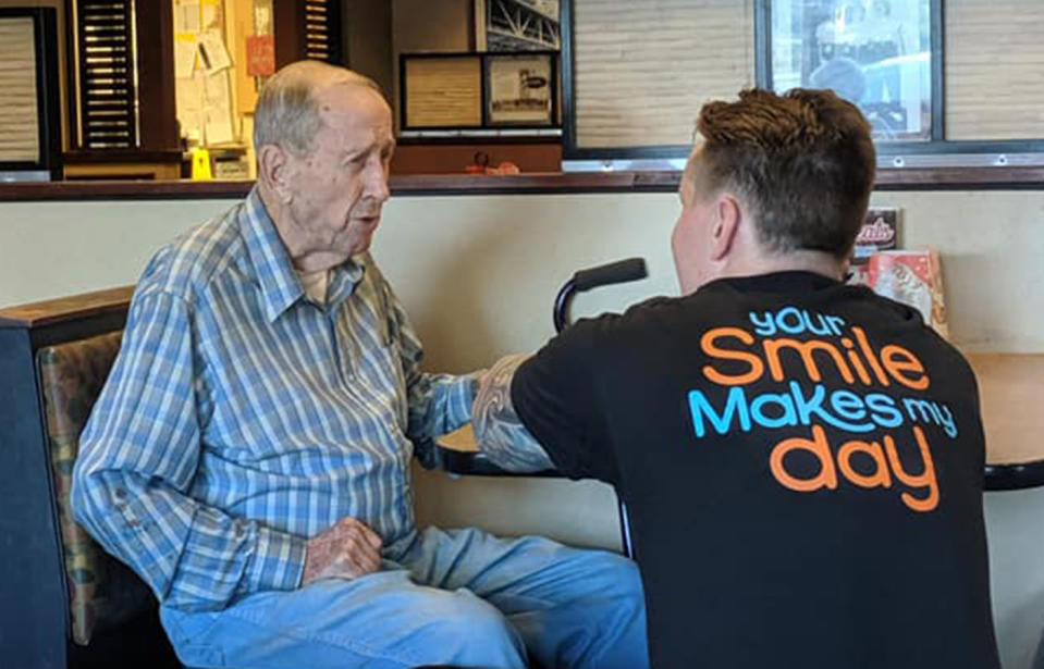 Restaurant worker Dylan Tetil gets closer to the elderly man so he could see and hear him better.