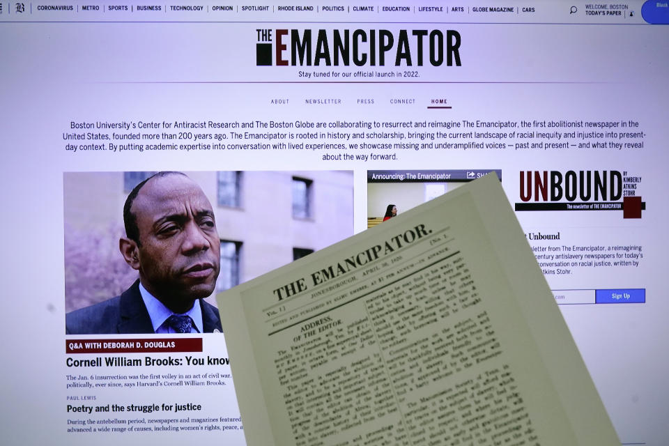 The new online publication of "The Emancipator" is pictured with a copy of the April 30, 1820, first edition of "The Emancipator", Wednesday, Feb. 2, 2022, in Boston. Boston University's Center for Antiracist Research and The Boston Globe's Opinion team are collaborating to resurrect and reimagine The Emancipator, the first abolitionist newspaper in the United States, which was founded more than 200 years ago. The new incarnation of The Emancipator will explore ways to reframe the national conversation around racial injustice. (AP Photo/Charles Krupa)