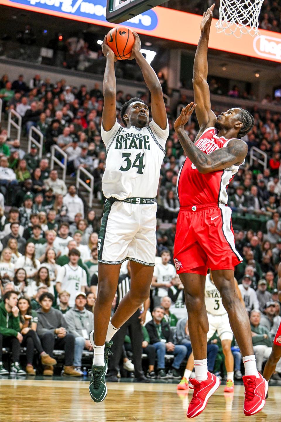 Michigan State's Xavier Booker, left, shoots as Ohio State's Felix Okpara defends during the first half on Sunday, Feb. 25, 2024, at the Breslin Center in East Lansing.