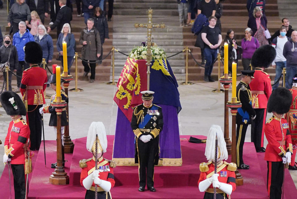 Britain's King Charles III attends a vigil around the coffin of Queen Elizabeth II, draped in the Royal Standard with the Imperial State Crown and the Sovereign's orb and sceptre, lying in state on the catafalque in Westminster Hall, at the Palace of Westminster in London on September 16, 2022