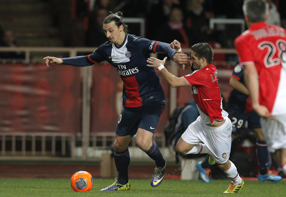 Paris Saint Germain's Zlatan Ibrahimovic of Sweden, left, challenges for the ball with Monaco's Joao Moutinho of Portugal during their French League One soccer match, in Monaco stadium, Sunday, Feb. 9 , 2014. (AP Photo/Lionel Cironneau)