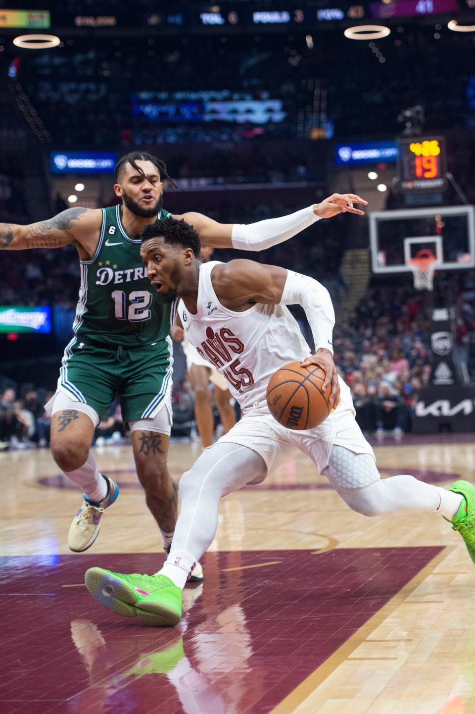 Cleveland Cavaliers' Donovan Mitchell (45) drives past Detroit Pistons' Isaiah Livers during the first half of an NBA basketball game in Cleveland, Saturday, March 4, 2023. (AP Photo/Phil Long)