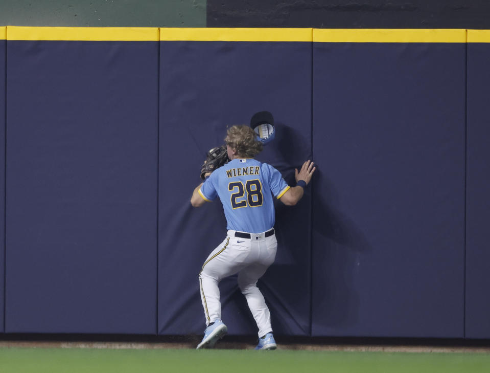 Milwaukee Brewers right fielder Joey Wiemer (28) catches a fly ball by Los Angeles Angels' Chad Wallach during the fourth inning of a baseball game Friday, April 28, 2023, in Milwaukee. (AP Photo/Jeffrey Phelps)