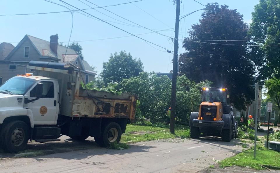 A city crew cleans up toppled trees on Davis Street in the City of Elmira on Tuesday, July 16, 2024 in the wake of severe thunderstorms that hammered the region Monday.