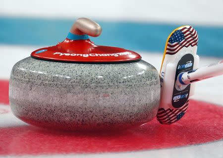 Curling - Pyeongchang 2018 Winter Olympics - Men's Semi-final - Canada v U.S. - Gangneung Curling Center - Gangneung, South Korea - February 22, 2018 - A stone and Team U.S. broom pad are seen during the game. REUTERS/Phil Noble