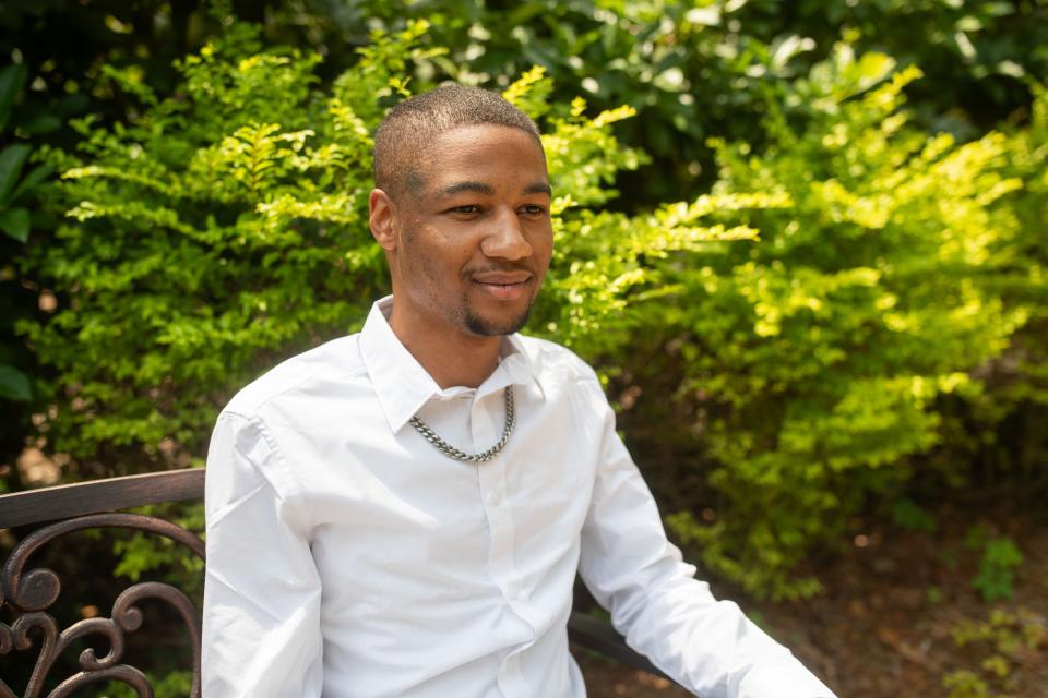 Elijah Pippin, 21, poses for a portrait in the backyard of the Joseph House on Thursday, May 9, 2024.