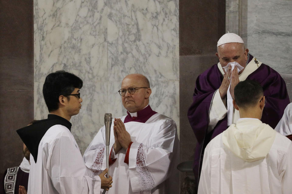 Pope Francis wipes his nose as he celebrates the Ash Wednesday Mass opening Lent, the forty-day period of abstinence and deprivation for Christians before Holy Week and Easter, in the Santa Sabina Basilica, in Rome, Wednesday, Feb. 26, 2020. Pope Francis celebrated the Ash Wednesday ritual kicking off the Catholic Church's Lenten season in traditional fashion, while other Masses in northern Italy were canceled over fears of the new coronavirus. (AP Photo/Gregorio Borgia)