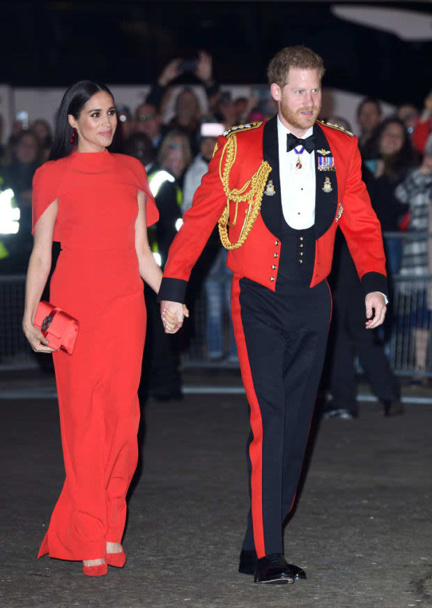 <p>March 2020 marked Harry and Meghan's last official appearances before stepping down as senior royals. At London’s Mountbatten Music Festival the Duchess of Sussex wore a red, caped, truly goddess-esque gown by Safiyaa to match her husband’s military uniform.</p>