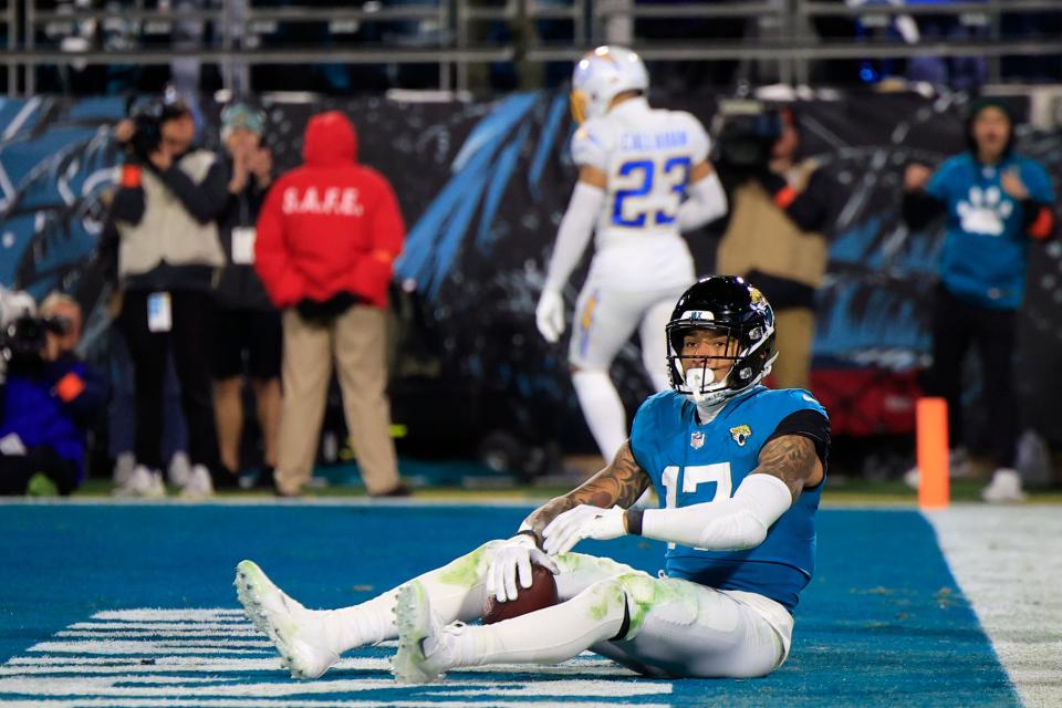 Jacksonville Jaguars tight end Evan Engram (17) sits in the end zone after scoring during the second quarter of an NFL first round playoff football matchup Saturday, Jan. 14, 2023 at TIAA Bank Field in Jacksonville, Fla. The Jacksonville Jaguars edged the Los Angeles Chargers on a field goal 31-30. [Corey Perrine/Florida Times-Union]