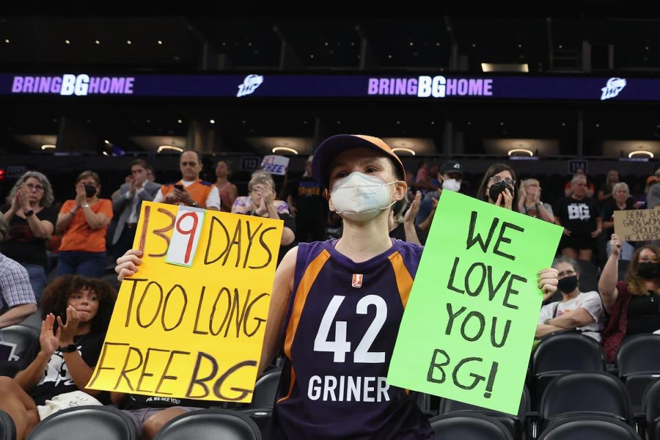 A supporter holds up signs during a rally to support the release of Griner (Getty)
