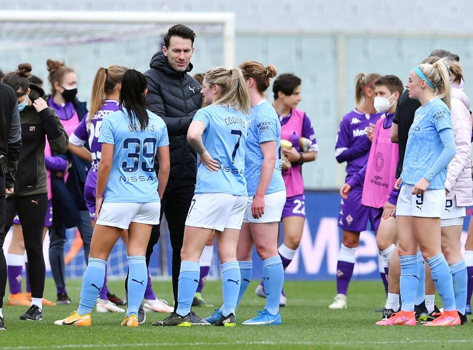 Manchester City head coach Gareth Taylor celebrates with players following a 2021 Champions League victory.