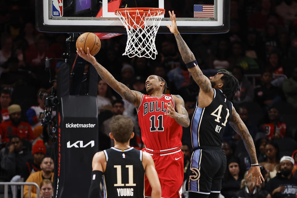 Chicago Bulls forward DeMar DeRozan, center, scores over Atlanta Hawks forward Saddiq Bey, left, during the second half of an NBA basketball game Monday, Feb. 12, 2024, in Atlanta. (AP Photo/Alex Slitz)