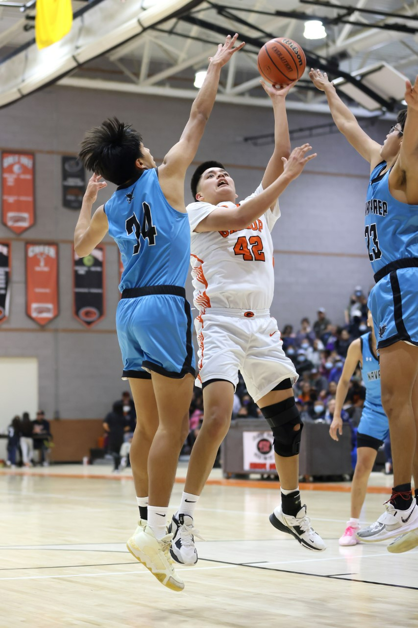 Gallup's Brett Baker shoots a jumper against Navajo Prep's Orion King (34) and Lucious Hale (23) in the third quarter of the Gallup Bengal Boys Invitational Basketball Tournament semifinal game on Friday, Jan. 6, 2023.