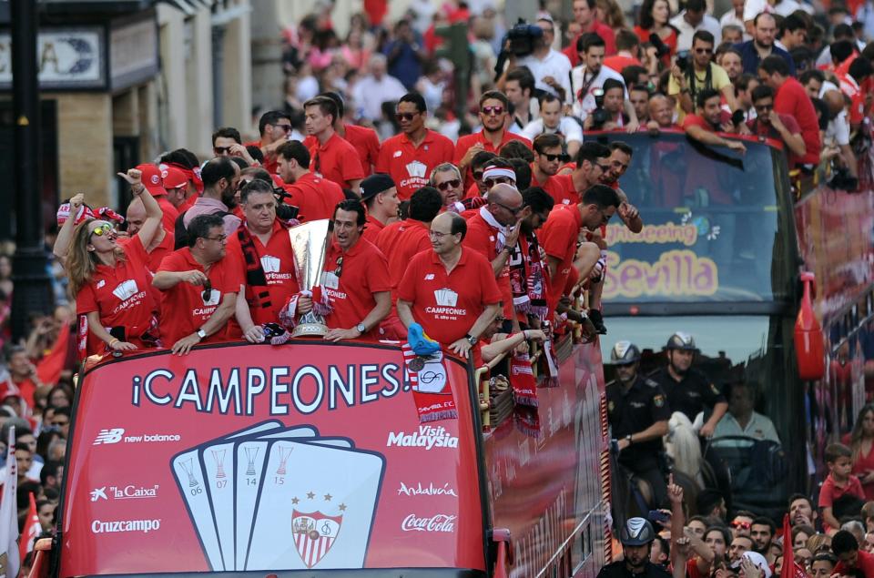 Sevilla team parade on top of a bus by a street of Sevilla to celebrate their victory in the 2015 Europa League final (CRISTINA QUICLER/AFP/Getty Images)