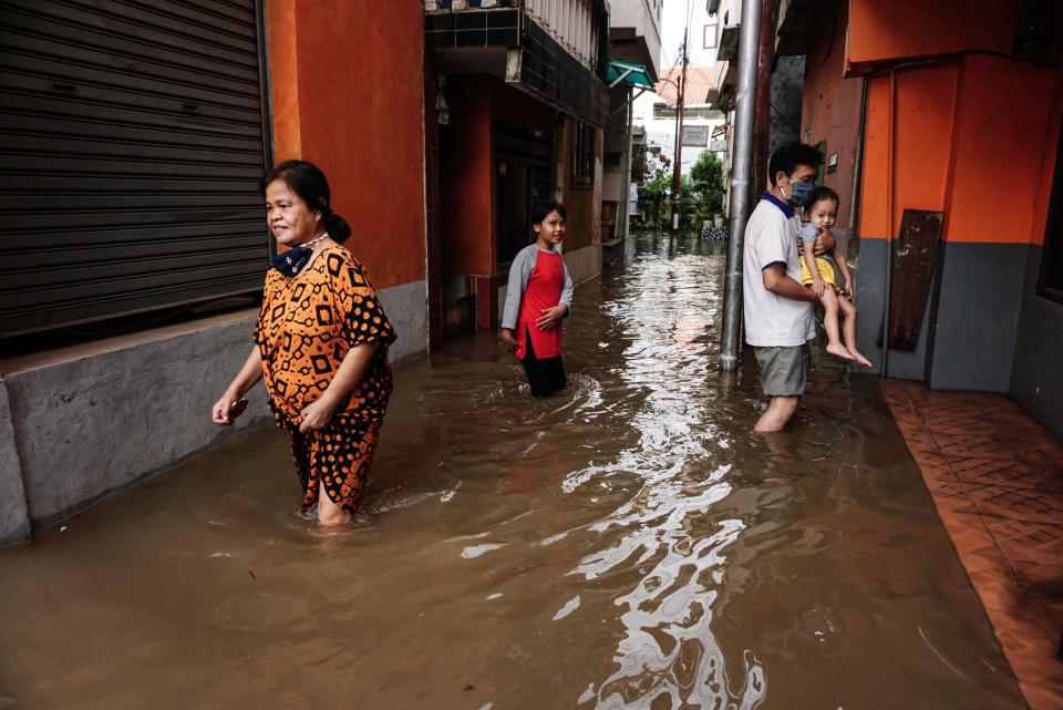 JAKARTA, Oct. 5, 2020 -- People walk through floodwater after a heavy rain at a residential area in Jakarta, Indonesia. Oct. 5, 2020. (Photo by Arya Manggala/Xinhua via Getty) (Xinhua/Arya Manggala via Getty Images)