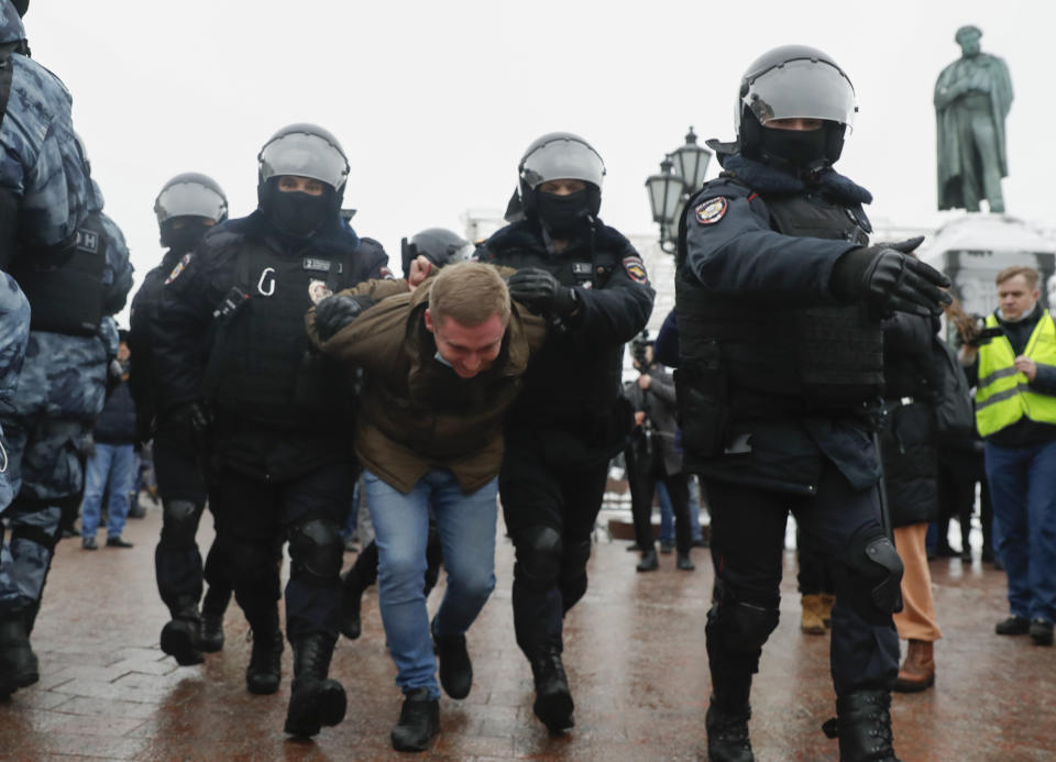 Police detain a man during a protest against the jailing of opposition leader Alexei Navalny in Moscow, Russia, Saturday, Jan. 23, 2021. Russian police are arresting protesters demanding the release of top Russian opposition leader Alexei Navalny at demonstrations in the country’s east and larger unsanctioned rallies are expected later Saturday in Moscow and other major cities. (AP Photo/Pavel Golovkin)