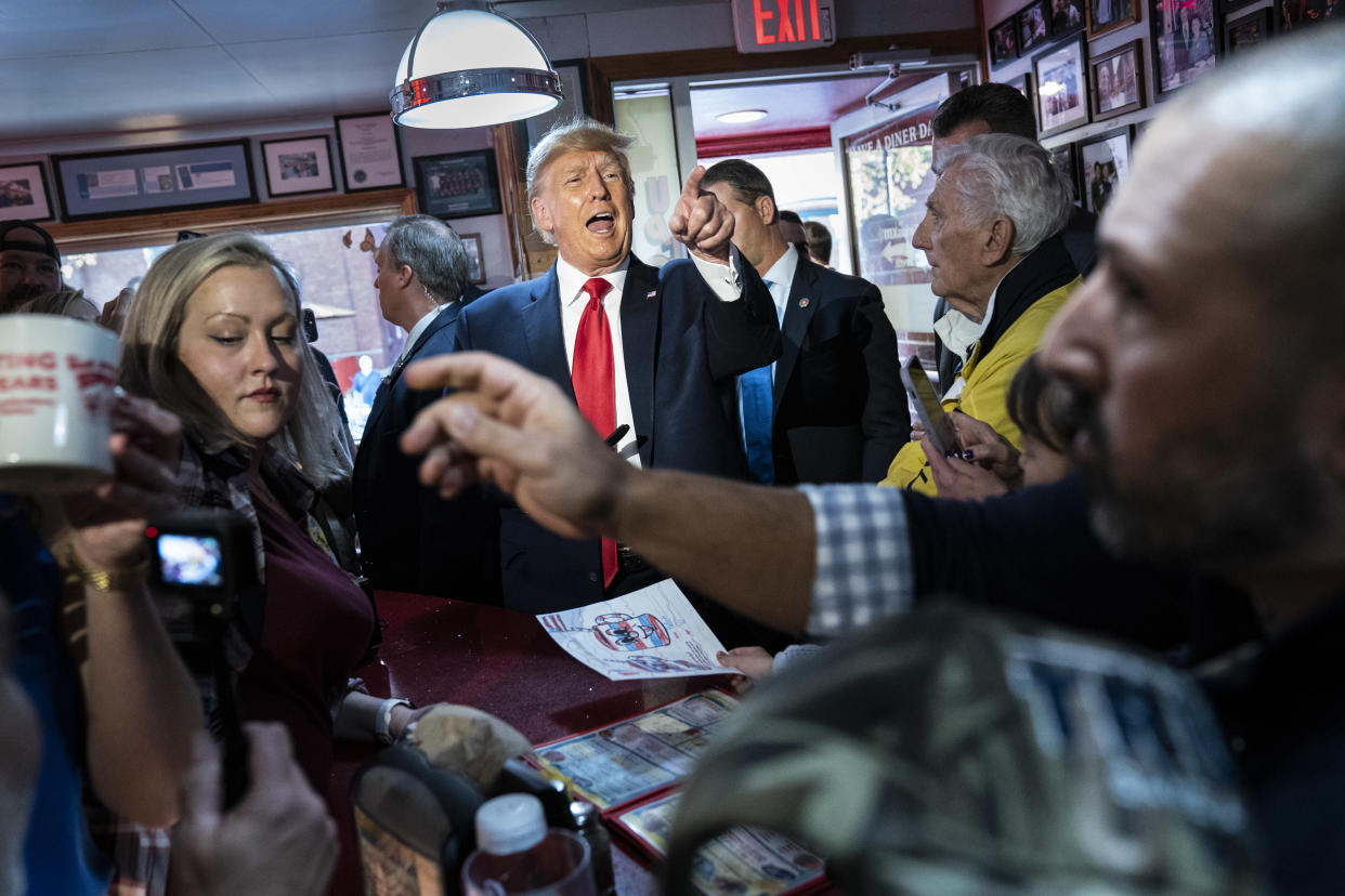 Donald Trump greets supporters at a diner.