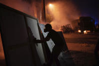 Protesters clash with police during a demonstration against the political elites and the government after this week's deadly explosion at Beirut port which devastated large parts of the capital, in Beirut, Lebanon, Saturday, Aug. 8, 2020. (AP Photo/Felipe Dana)