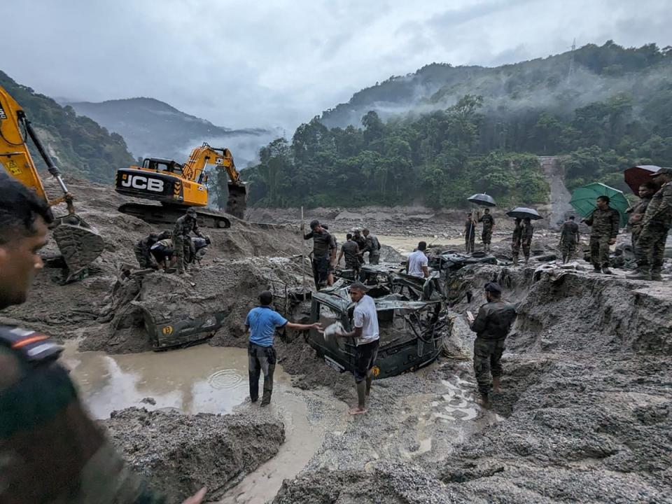 This handout picture released by India’s Ministry of Defence on 5 October 2023, shows Indian army personnel conduct a search operation for the missing soldiers in north Sikkim (India's Ministry of Defence/AFP)