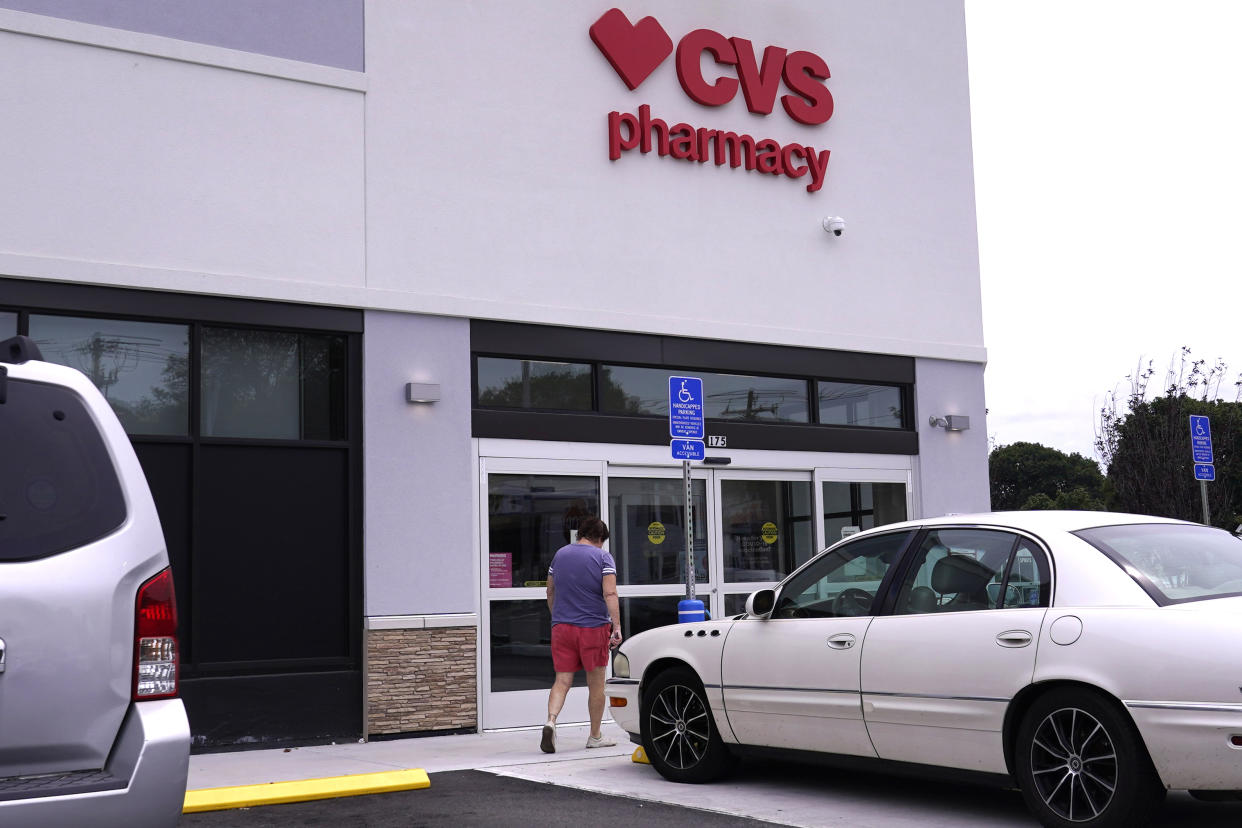 FILE - A customer walks into a CVS Pharmacy store, Tuesday, Aug. 3, 2021, in Woburn, Mass. The Food and Drug Administration said Wednesday, July 6, 2022, that pharmacies could now prescribe Pfizer's Paxlovid pill directly to COVID-19 patients. (AP Photo/Charles Krupa, File)