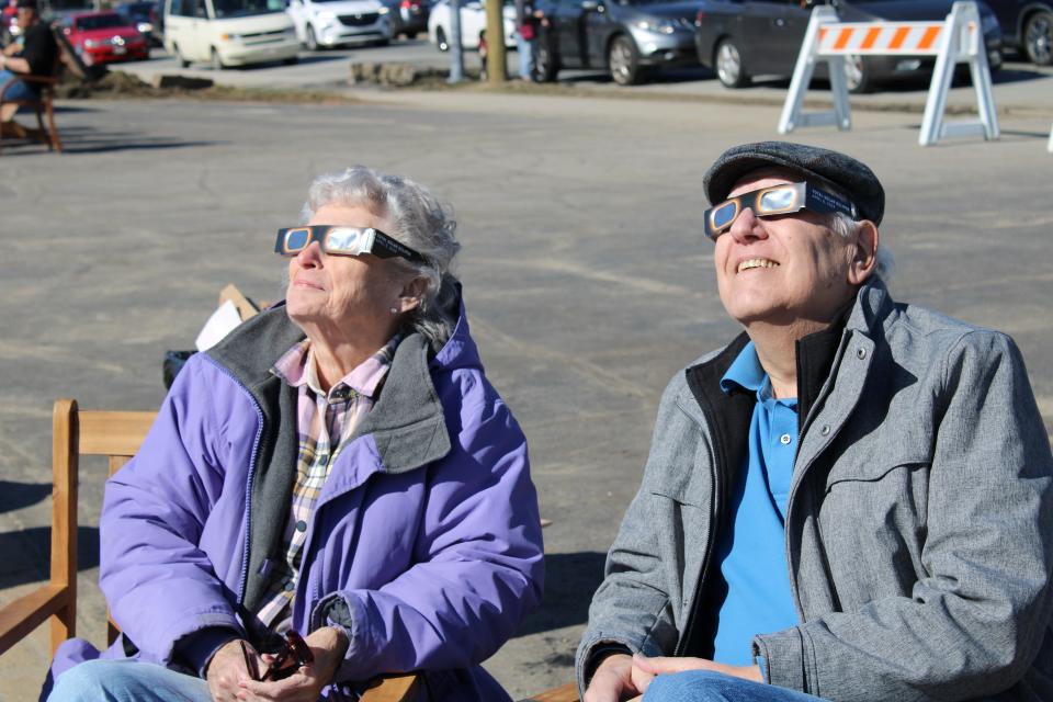 Paul Broce and Bea Zakur look up at the sun a little while after the total eclipse.