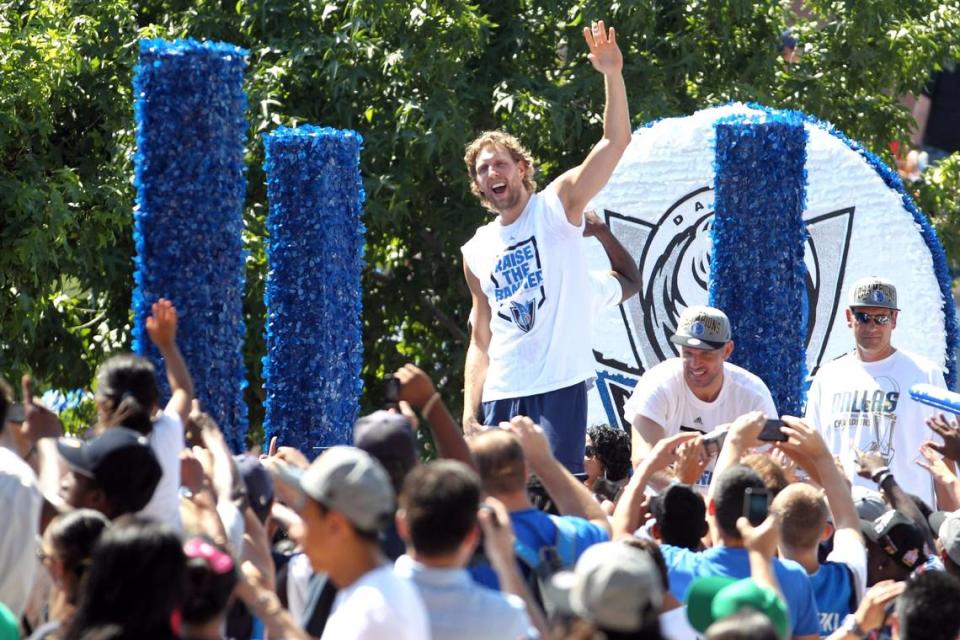 Dallas Mavericks’ Dirk Nowitzki waves to fans during the Dallas Mavericks parade at the American Airlines Center following the 2011 championship season.