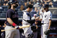 New York Yankees catcher Gary Sanchez, center, hands the ball to relief pitcher Albert Abreu, right, after catching pop out by Cleveland Indians' Austin Hedges, left, in the fifth inning of a baseball game, Saturday, Sept. 18, 2021, in New York. (AP Photo/John Minchillo)