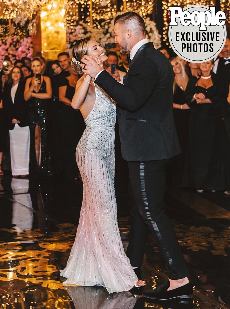 When it came time for the reception, Tebow expected to see his wife in the same design. But Nel-Peters decided to surprise him with another custom gown created for her by the <a href="https://www.pjatr.com/t/8-11209-131940-146778?sid=PEO%2CAllAbouttheTwoGorgeousWeddingDressesDemi-LeighNel-PetersWoretoMarryTimTebow%2Ckaitlynfrey%2CUnc%2CPos%2C7590171%2C202001%2CI&url=https%3A%2F%2Fwww.davidsbridal.com%2F" rel="nofollow noopener" target="_blank" data-ylk="slk:David's Bridal;elm:context_link;itc:0;sec:content-canvas" class="link ">David's Bridal</a> team. “The second dress is more modern, sensual and fun,” she said of the Chantilly lace and crystal-embellished column with a plunging V-neckline, worn with a walking-length two-tier veil. “It’s something I could enjoy myself in. I hope it is everything Tim imagined it to be as well!”