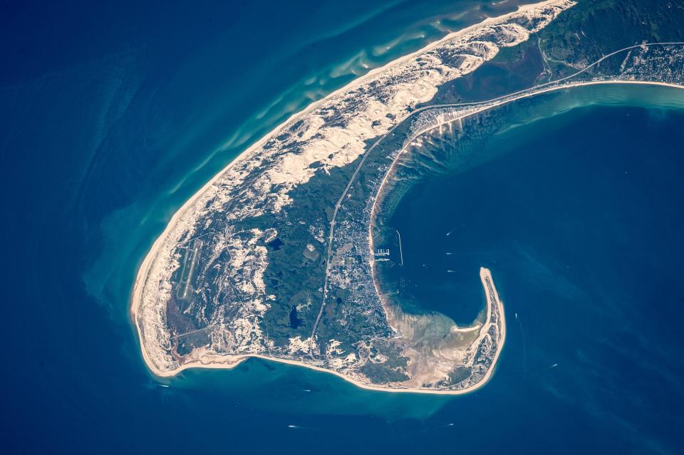 Cape Cod: Astronaut photograph ISS044-E-610 was acquired on June 13, 2015, with a Nikon D4 digital camera using an 1150 millimeter lens, and is provided by the ISS Crew Earth Observations Facility and the Earth Science and Remote Sensing Unit, Johnson Space Center. The image was taken by a member of the Expedition 44 crew. The image has been cropped and enhanced to improve contrast, and lens artifacts have been removed. The International Space Station Program supports the laboratory as part of the ISS National Lab to help astronauts take pictures of Earth that will be of the greatest value to scientists and the public, and to make those images freely available on the Internet.