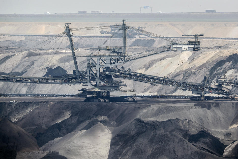 Giant bucket-wheel excavators extract coal at the controversial Garzweiler surface coal mine near Jackerath, west Germany, Thursday, April 29, 2021. Germany's top court ruled Thursday that the country's government has to set clear goals for reducing greenhouse gas emissions after 2030, arguing that current legislation doesn't go far enough in ensuring that climate change is limited to acceptable levels. (AP Photo/Martin Meissner)
