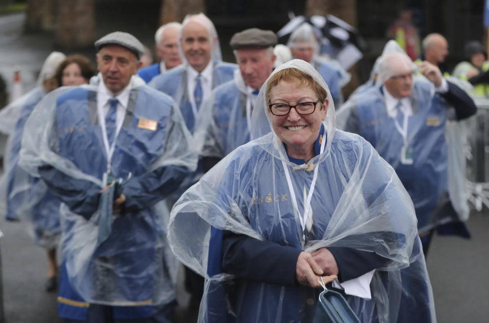 People wait for the arrival of Pope Francis in front of the Knock Shrine, in Knock, Ireland, Sunday, Aug. 26, 2018. Pope Francis is on a two-day visit to Ireland. (Niall Carson/PA via AP)