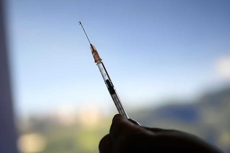 FILE - A healthcare worker prepares a dose of the Sputnik V vaccine for COVID-19 as seniors and those considered high risk for contagion are eligible at a vaccination center set up in the parking lot of the Armed Forces Social Prevision Institute (IPSFA) in Caracas, Venezuela, June 7, 2021. On Monday, the U.S. will implement a new air travel policy to allow in foreign citizens who have completed a course of a vaccine approved by the Food and Drug Administration or the World Health Organization. That leaves people in Mexico, Hungary, Russia and elsewhere who received the non-approved Russian Sputnik V vaccine or the China-produced CanSino vaccine ineligible to board U.S.-bound flights. (AP Photo/Matias Delacroix,. File)