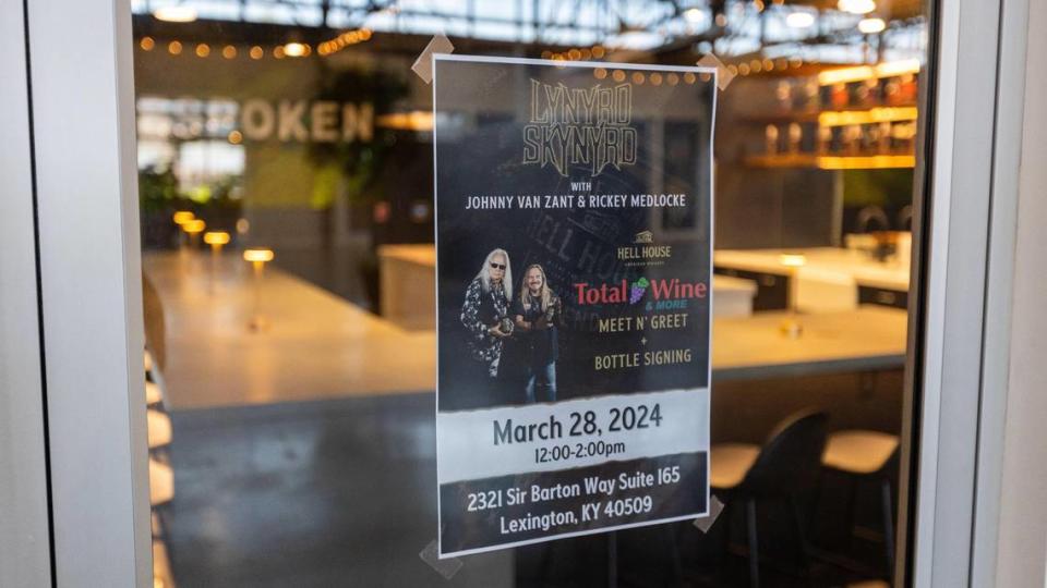 A poster announcing a Lynyrd Skynyrd meet and greet and bottle signing taped to Bespoken Spirits tasting room’s door in Greyline Station. the grand opening will be March 27.