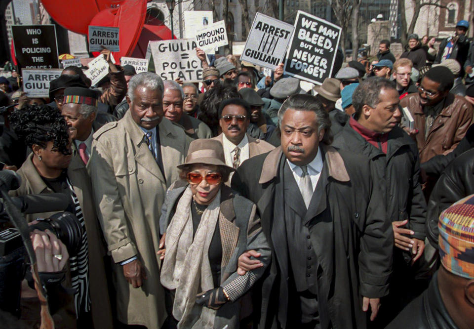 FILE - In this March 23, 1999, file photo, the Rev. Al Sharpton, center right, walks with actors and activists Ruby Dee, center, and her husband Ossie Davis, center left, at New York's police headquarters during protests calling for the arrest of the police officers who fired 41 bullets at West African immigrant Amadou Diallo, killing him. For more than three decades, Sharpton, 65, has been a go-to advocate for Black American families seeking justice and peace in the wake of violence and countless incidents that highlight systemic racism. (AP Photo/Ed Bailey, File)