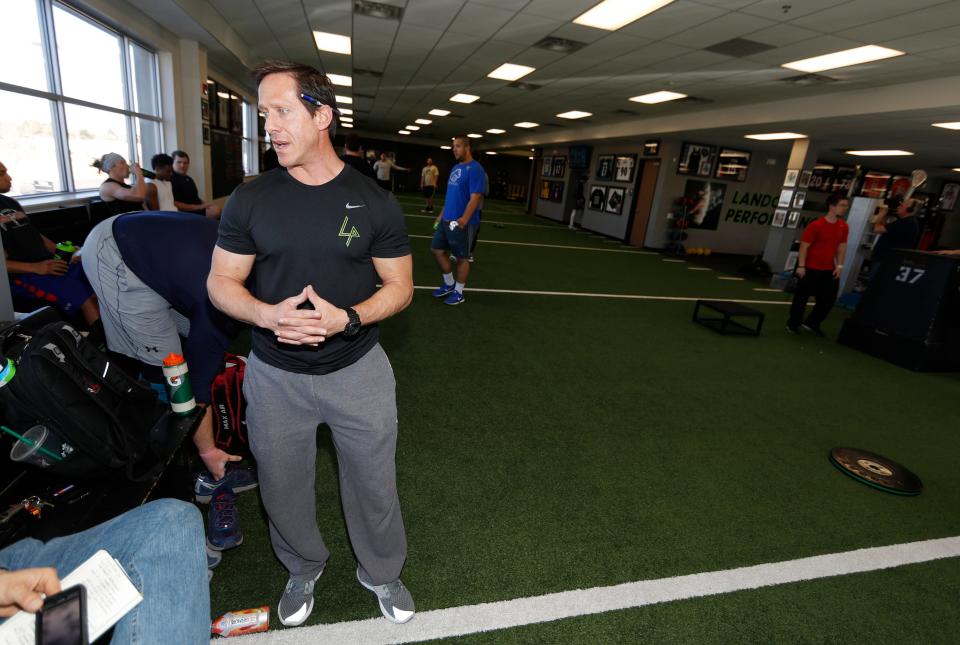In this Thursday, Feb. 16, 2017, photograph, trainer Loren Landow takes a break while supervising drills to prepare hopefuls for the NFL combine, at a workout facility in Centennial, Colo. Landow has been working to ready some of the 330 players who will be arriving at the NFL's annual combine this week in Indianapolis. (AP Photo/David Zalubowski)