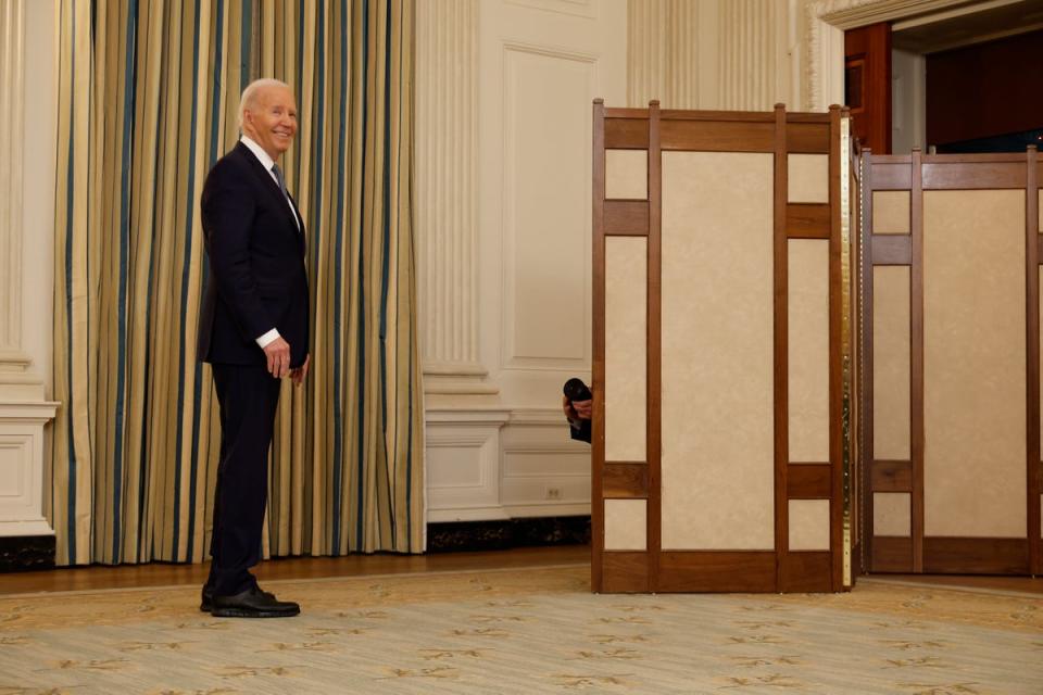 Biden grins as a reporter asks him about Trump calling himself a ‘political prisoner’ (Getty Images)