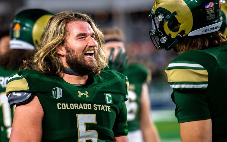 CSU football's junior tight end Dallin Holker is all smiles on the sideline after scoring the Rams' opening touchdown against San Diego State at Canvas Stadium on Saturday, Nov. 11, 2023.