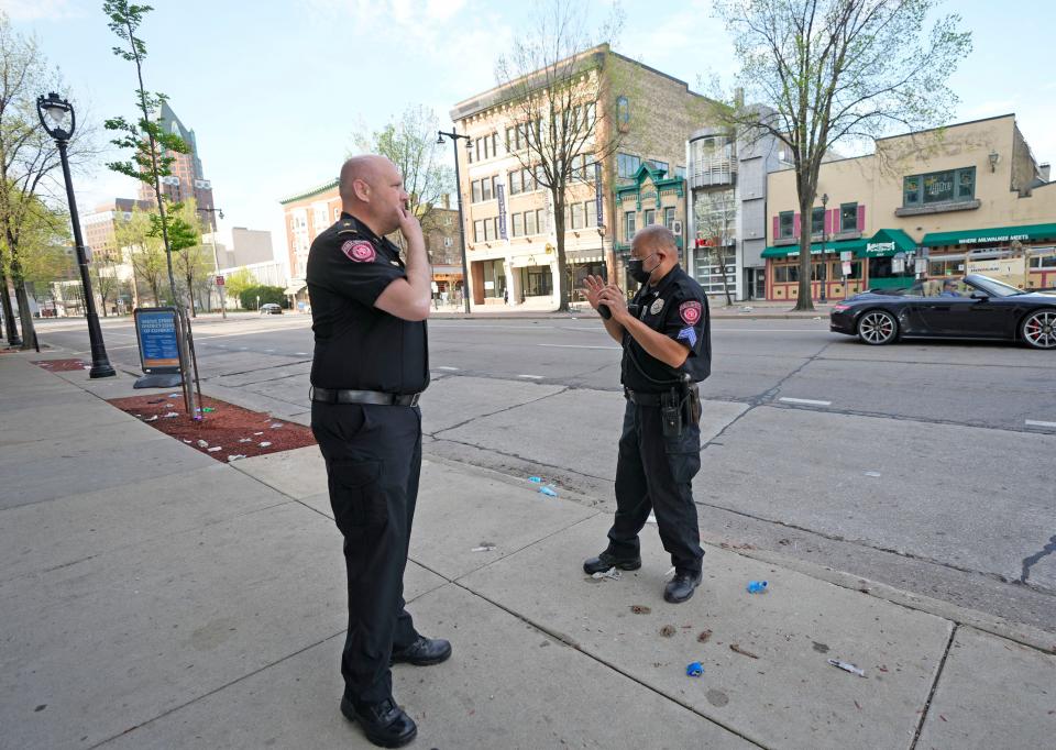 MSOE Public Safely officers investigate the scene near the corner of North Water Street and East Juneau Avenue in Milwaukee on Saturday, May 14, 2022 where 17 people, ranging in age from 15 to 47, were shot and injured in Milwaukee's downtown entertainment district after the Bucks' playoff game against the Boston Celtics in the Eastern Conference semifinals.